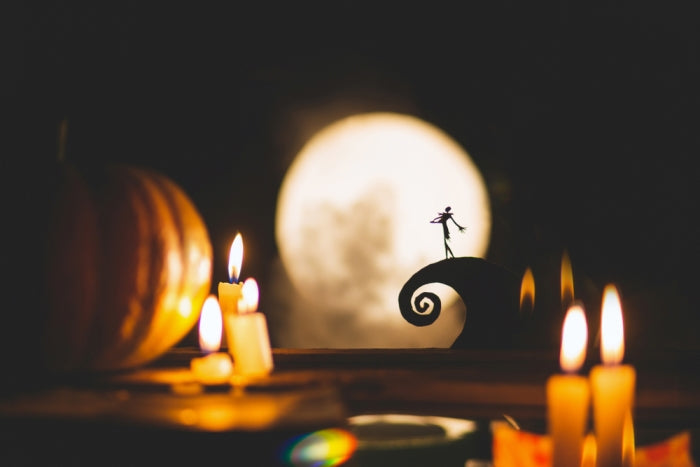 The silhouette of a lanky Jack Skellington stands out against the stunning backdrop of a full moon.  
